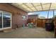 View of the covered patio featuring a table, chairs, fenced perimeter, and access to the building at 9044 E Nassau Ave, Denver, CO 80237