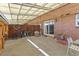 The partially covered patio with brick accents offers a versatile outdoor space for dining and leisure at 9044 E Nassau Ave, Denver, CO 80237