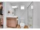 Well-lit bathroom with wood cabinets, large mirror, separate shower, and modern fixtures, providing a functional space at 210 S Old Hammer Ct, Aurora, CO 80018