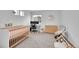 Bedroom featuring a crib, changing table, modern desk, and neutral decor, creating a calm and inviting atmosphere at 210 S Old Hammer Ct, Aurora, CO 80018