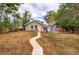 Charming home featuring a spacious backyard with a stone walkway, and an inviting seating area at 3074 S Elati St, Englewood, CO 80110
