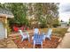 Backyard setup with two decks, blue Adirondack chairs, and red table with chairs at 3074 S Elati St, Englewood, CO 80110
