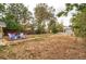 Large, grassy backyard with a fire pit and seating area for outdoor enjoyment at 3074 S Elati St, Englewood, CO 80110