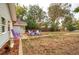Spacious backyard with fire pit, chairs, wooden fence, and partial view of home exterior at 3074 S Elati St, Englewood, CO 80110