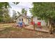 Backyard setup with two decks, blue Adirondack chairs, and red table with chairs at 3074 S Elati St, Englewood, CO 80110