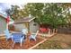 Backyard setup with two decks, blue Adirondack chairs, and red table with chairs at 3074 S Elati St, Englewood, CO 80110