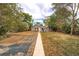 Charming home featuring a spacious backyard with a stone walkway, and an inviting seating area at 3074 S Elati St, Englewood, CO 80110