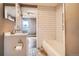 Updated bathroom featuring subway tile, a classic vanity, and a bathtub at 3074 S Elati St, Englewood, CO 80110
