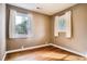 Bright bedroom with hardwood floors, neutral walls, and double windows for natural light at 3074 S Elati St, Englewood, CO 80110