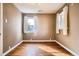 Empty bedroom featuring hardwood floors, baseboard trim and two windows at 3074 S Elati St, Englewood, CO 80110