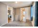 Bedroom with view into kitchen and bath, plus neutral walls and carpeted floor at 3074 S Elati St, Englewood, CO 80110
