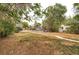 Large front yard with mature trees and a pathway leading to the house at 3074 S Elati St, Englewood, CO 80110