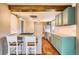 Modern kitchen featuring stainless steel appliances, island, and hardwood floors at 3074 S Elati St, Englewood, CO 80110