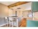 Modern kitchen featuring stainless steel appliances, island, and hardwood floors at 3074 S Elati St, Englewood, CO 80110