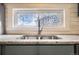 Kitchen sink features decorative window and granite countertops at 3074 S Elati St, Englewood, CO 80110