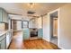 Modern kitchen with blue cabinets, stainless steel appliances, and a hardwood floor at 3074 S Elati St, Englewood, CO 80110