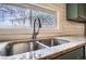 Close-up of kitchen sink with stainless steel faucet and decorative privacy window at 3074 S Elati St, Englewood, CO 80110