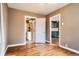 View of the living room, doorway to bathroom, and kitchen with blue cabinets at 3074 S Elati St, Englewood, CO 80110