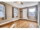 Sunlit living room featuring hardwood floors, modern windows, and a stylish front door at 3074 S Elati St, Englewood, CO 80110
