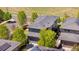 Aerial shot of a modern home with solar panels, lush trees, and a well-kept lawn at 9154 E 37Th Ave, Denver, CO 80238