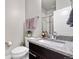 Stylish bathroom featuring a granite countertop, modern fixtures, and tiled shower with glass door at 9154 E 37Th Ave, Denver, CO 80238