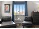 Bedroom sitting area featuring dark leather furniture and a bright window at 9154 E 37Th Ave, Denver, CO 80238