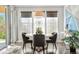 Bright dining area with modern lighting, large windows, and a round table with comfortable seating at 9154 E 37Th Ave, Denver, CO 80238