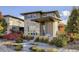 Modern two-story home features a unique architectural design with professional landscaping and inviting front porch at 9154 E 37Th Ave, Denver, CO 80238