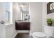 Well-lit half bath features granite countertop, dark wood vanity, and modern fixtures at 9154 E 37Th Ave, Denver, CO 80238