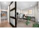 Bright home office with large windows, modern decor, and stylish barn-door entry and storage at 9154 E 37Th Ave, Denver, CO 80238