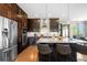 Well-equipped kitchen with stainless steel appliances, dark wood cabinets, and granite countertops with bar seating at 9154 E 37Th Ave, Denver, CO 80238