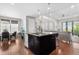 Stylish kitchen with a granite countertop island, stainless steel appliances, and open to the living area at 9154 E 37Th Ave, Denver, CO 80238