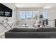 Bright living room with large windows, comfortable gray sofa, and modern decor at 9154 E 37Th Ave, Denver, CO 80238