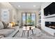 Bright living room with large windows, modern fireplace, and a comfortable seating area at 9154 E 37Th Ave, Denver, CO 80238