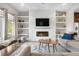 Cozy living room with fireplace, built-in shelves, and comfortable seating at 9154 E 37Th Ave, Denver, CO 80238