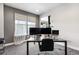 Bright home office with large windows, gray walls, and stylish desk setup for working from home at 9154 E 37Th Ave, Denver, CO 80238