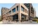 Modern building boasts a commercial space with outdoor seating under stylish umbrellas, offering a vibrant urban experience at 838 N Cherry St # 1, Denver, CO 80220