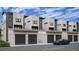 Modern townhomes with gray-toned siding and brick exteriors feature car garages for convenient parking at 838 N Cherry St # 1, Denver, CO 80220