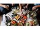 Top-down view of beautifully arranged food, drinks and people eating at a table with curated small plates for sharing at 838 N Cherry St # 1, Denver, CO 80220