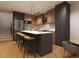 Stylish kitchen featuring a large island with seating, stainless steel appliances, and modern cabinetry at 838 N Cherry St # 1, Denver, CO 80220