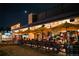 Postino's outdoor patio at night; bright yellow umbrellas offer a lively and inviting al fresco dining experience at 838 N Cherry St # 1, Denver, CO 80220