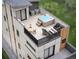 Rooftop patio with hot tub, seating, dining table, and outdoor furniture for relaxation and entertaining at 838 N Cherry St # 1, Denver, CO 80220