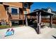 Backyard patio with gazebo, table, chairs, and cornhole game at 5952 E Conservation Dr, Frederick, CO 80504