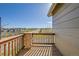 Balcony with wood railing offers scenic views of the surrounding neighborhood and landscape at 7511 S Sicily Way, Aurora, CO 80016
