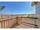 Balcony with wooden railing offering neighborhood views on a sunny day at 7511 S Sicily Way, Aurora, CO 80016