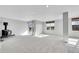 This basement has gray paint and carpet, a wood stove, and a sliding glass door to the outside at 7511 S Sicily Way, Aurora, CO 80016