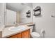 Bathroom features a single sink vanity and decorative shelving for a stylish touch at 7511 S Sicily Way, Aurora, CO 80016