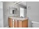 A bathroom featuring a double sink vanity, a toilet, and neutral colored paint at 7511 S Sicily Way, Aurora, CO 80016