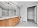 A bathroom featuring a double sink vanity, a toilet, neutral paint, and a closet space at 7511 S Sicily Way, Aurora, CO 80016