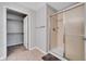 Bathroom featuring a glass-enclosed shower, tile flooring, and a walk-in closet at 7511 S Sicily Way, Aurora, CO 80016